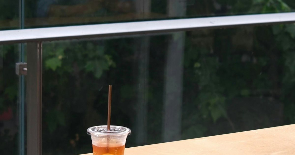 Refreshing iced tea with lemon resting on an outdoor patio bench